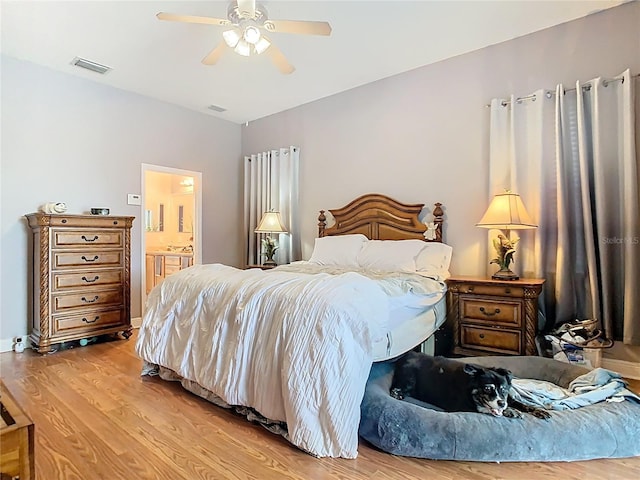 2420 Windchaser Ct, Melbourne, FL 32904 - bedroom featuring visible vents, ceiling fan, connected bathroom, and wood finished floors