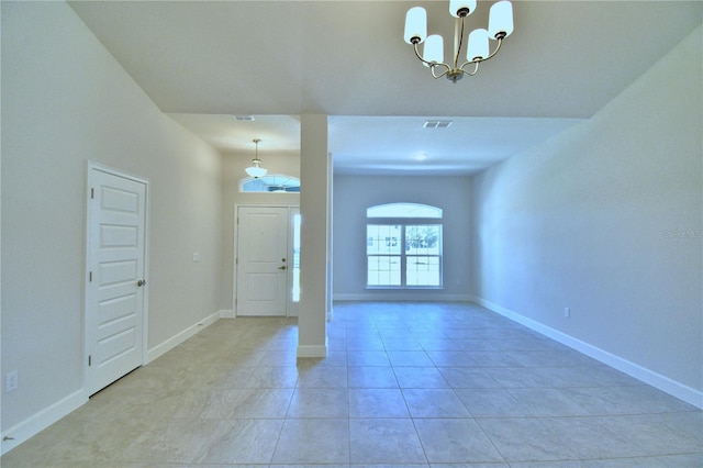 foyer featuring light tile patterned floors, a notable chandelier, baseboards, and visible vents