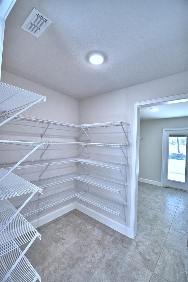 walk in closet with visible vents