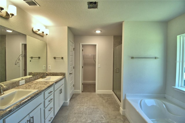 bathroom featuring a sink, visible vents, a stall shower, and a bath
