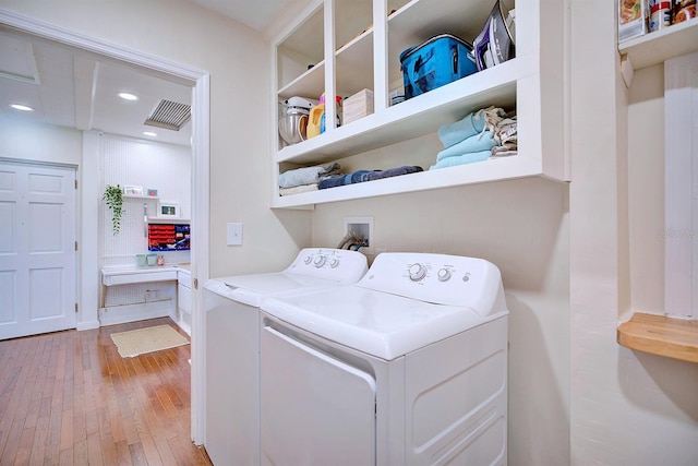 2816 Fairmount Ave, Lakeland, FL 33803 - laundry area with light wood-style floors, washing machine and clothes dryer, and recessed lighting