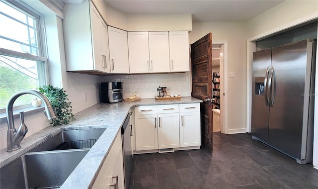 2816 Fairmount Ave, Lakeland, FL 33803 - kitchen featuring stainless steel fridge, backsplash, and white cabinetry