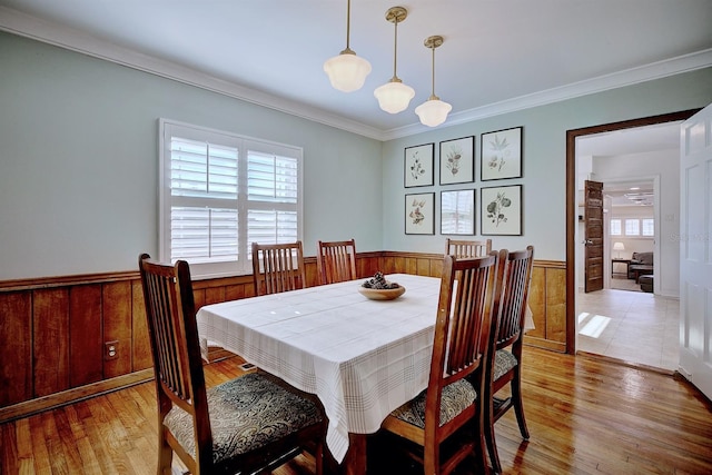 2816 Fairmount Ave, Lakeland, FL 33803 - dining space featuring wainscoting, wood finished floors, ornamental molding, and wooden walls