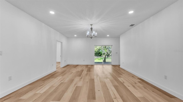unfurnished room featuring a notable chandelier, light wood-style floors, visible vents, and recessed lighting