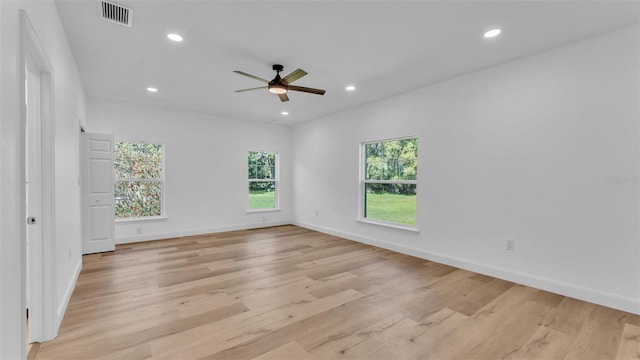 spare room with a healthy amount of sunlight, a ceiling fan, visible vents, and recessed lighting