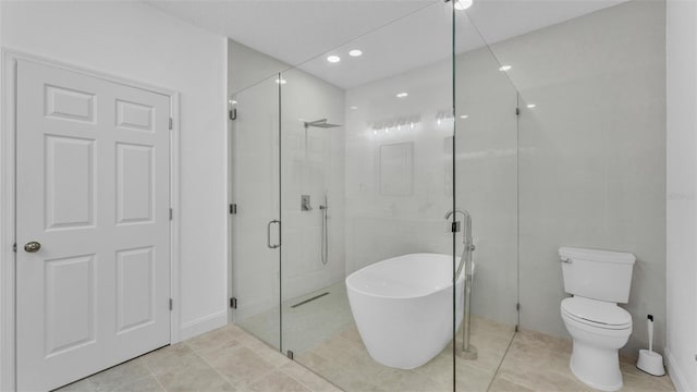 full bath featuring a stall shower, recessed lighting, toilet, tile patterned flooring, and a soaking tub