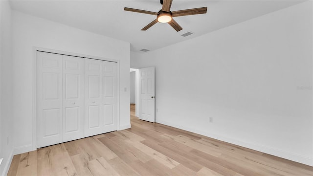 unfurnished bedroom with baseboards, visible vents, and light wood-style floors