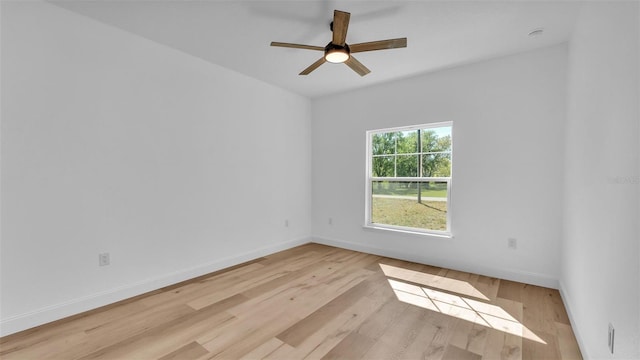 unfurnished room featuring baseboards, light wood-style floors, and ceiling fan