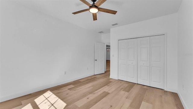 unfurnished bedroom with baseboards, light wood finished floors, and visible vents