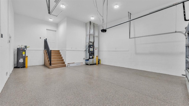 garage with water heater and concrete block wall