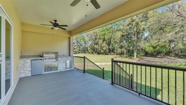 view of patio / terrace featuring grilling area, exterior kitchen, and a ceiling fan