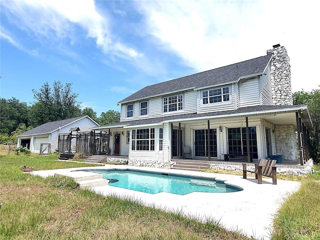 8922 Pritcher Rd, Lithia, FL 33547 - back of property featuring a chimney, an outdoor pool, and roof with shingles