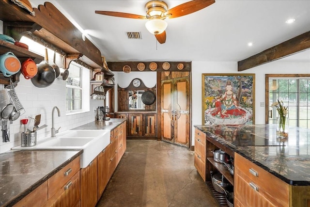 8922 Pritcher Rd, Lithia, FL 33547 - kitchen featuring concrete floors, brown cabinetry, open shelves, decorative backsplash, and a ceiling fan