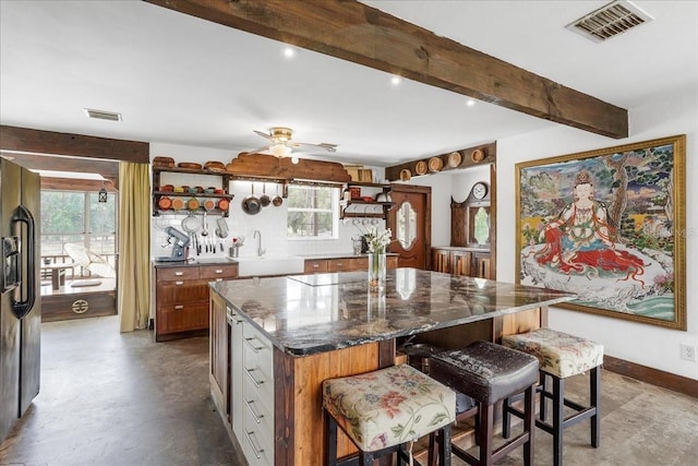 8922 Pritcher Rd, Lithia, FL 33547 - kitchen with open shelves, a sink, healthy amount of natural light, a center island, and beamed ceiling