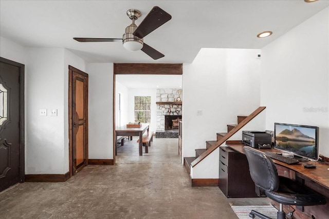 8922 Pritcher Rd, Lithia, FL 33547 - office space with baseboards, a stone fireplace, ceiling fan, and concrete floors