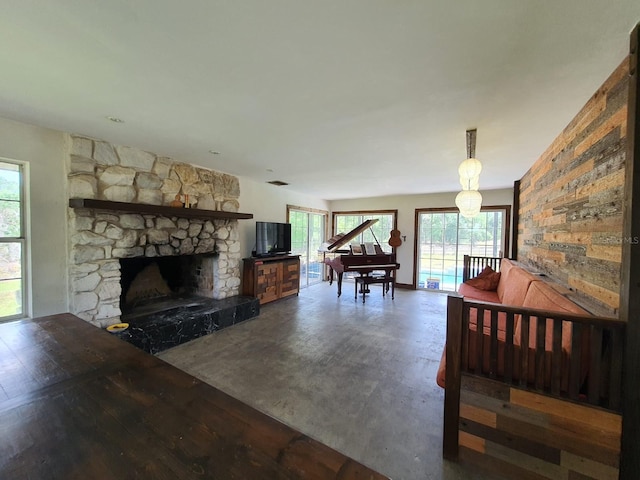 8922 Pritcher Rd, Lithia, FL 33547 - living area featuring healthy amount of natural light, wood finished floors, and a stone fireplace