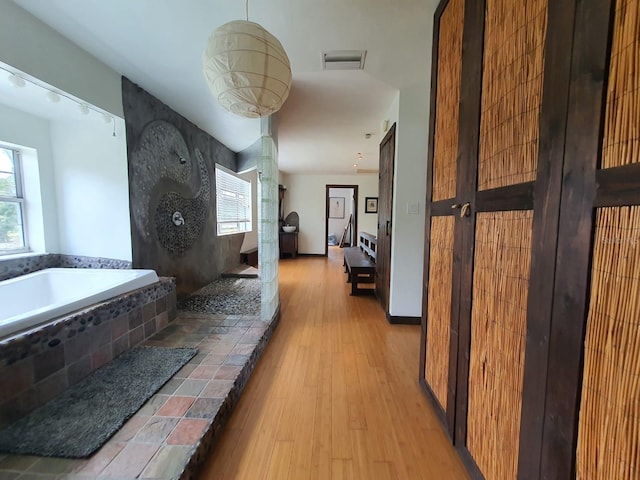 8922 Pritcher Rd, Lithia, FL 33547 - full bath featuring healthy amount of natural light, walk in shower, wood finished floors, and a bath
