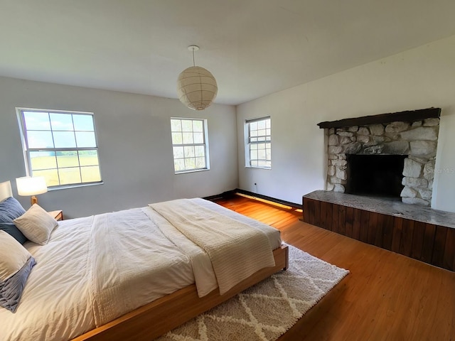 8922 Pritcher Rd, Lithia, FL 33547 - bedroom featuring wood finished floors and a stone fireplace