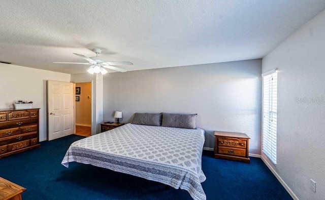 720 Cedar Knoll Dr N, Lakeland, FL 33809 - bedroom featuring baseboards, a ceiling fan, carpet flooring, and a textured ceiling