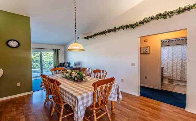 720 Cedar Knoll Dr N, Lakeland, FL 33809 - dining room with baseboards, lofted ceiling, and wood finished floors