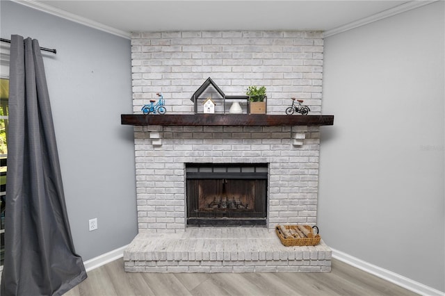 details with baseboards, a brick fireplace, wood finished floors, and crown molding