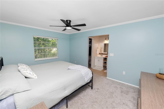 carpeted bedroom featuring crown molding, baseboards, ceiling fan, and ensuite bathroom