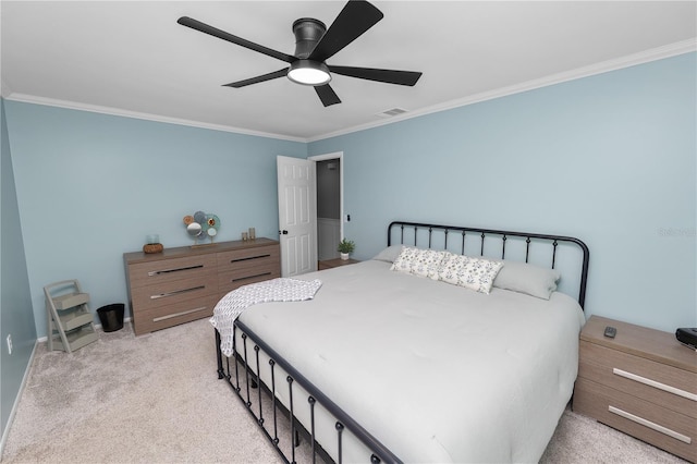 bedroom featuring ceiling fan, visible vents, light carpet, and ornamental molding