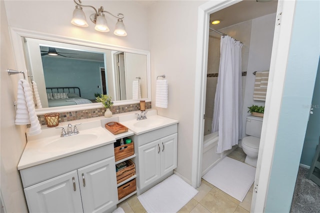 ensuite bathroom with connected bathroom, shower / tub combo with curtain, a sink, and double vanity