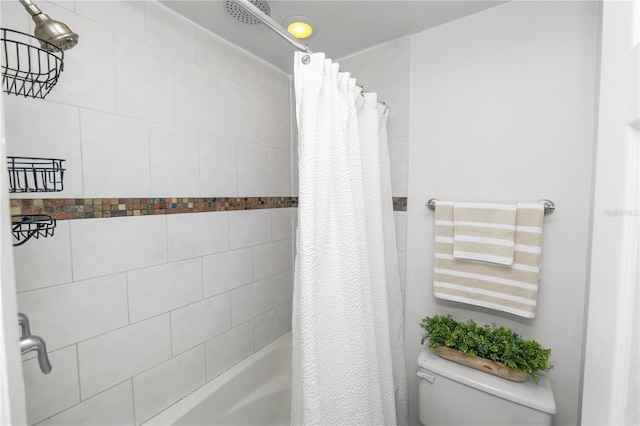 full bathroom featuring shower / tub combo and toilet