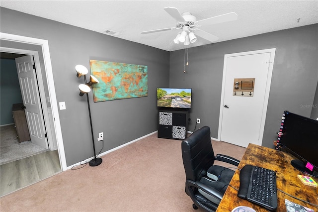 home office featuring baseboards, visible vents, carpet, and ceiling fan