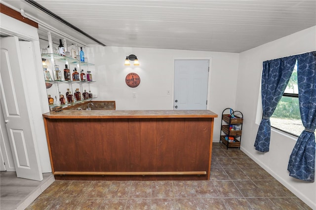 bar featuring bar and baseboards