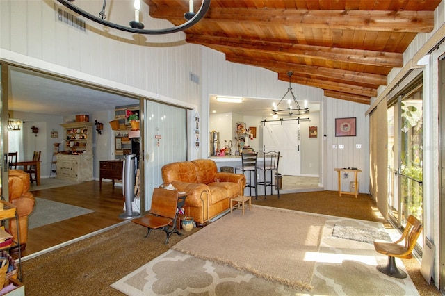 living area featuring lofted ceiling with beams, visible vents, wood ceiling, and an inviting chandelier