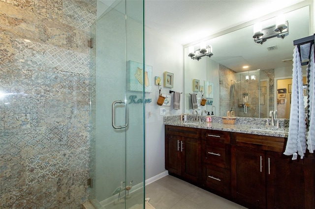 full bath featuring a shower stall, double vanity, visible vents, and a sink