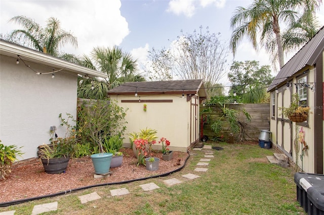 view of yard featuring a fenced backyard, a shed, and an outdoor structure