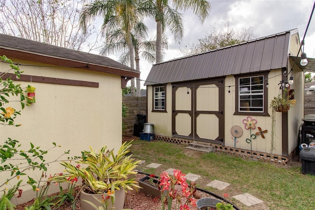 view of shed featuring fence