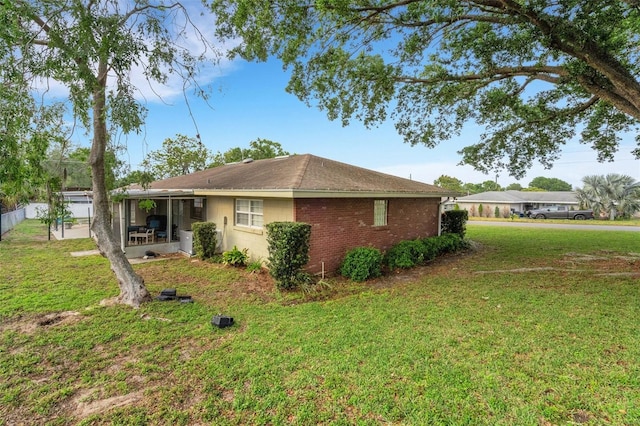 202 Saint Lucie Rd, Winter Haven, FL 33884 - view of side of home with a patio area and a lawn