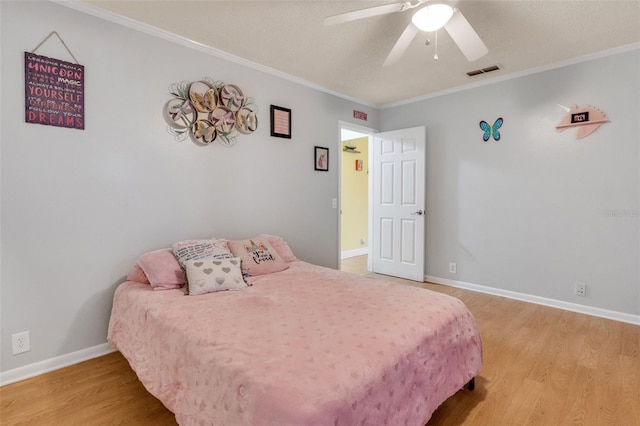 202 Saint Lucie Rd, Winter Haven, FL 33884 - bedroom with light wood-style floors, crown molding, baseboards, a ceiling fan, and a textured ceiling