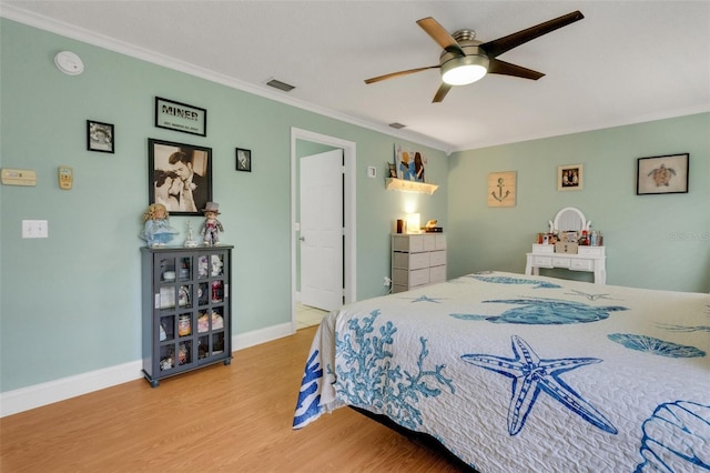 202 Saint Lucie Rd, Winter Haven, FL 33884 - bedroom with wood finished floors, crown molding, baseboards, and ceiling fan
