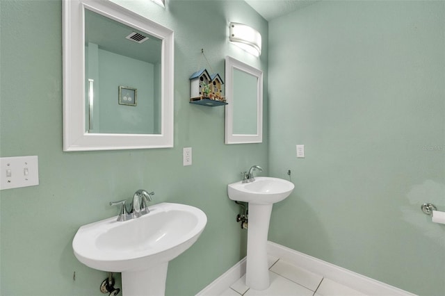 202 Saint Lucie Rd, Winter Haven, FL 33884 - bathroom with tile patterned flooring, baseboards, and a sink