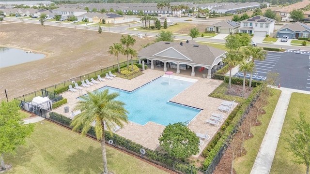 drone / aerial view with a water view and a residential view