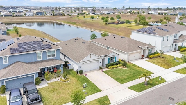 birds eye view of property with a residential view and a water view