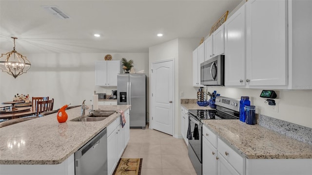 kitchen with white cabinetry, a sink, stainless steel appliances, and visible vents