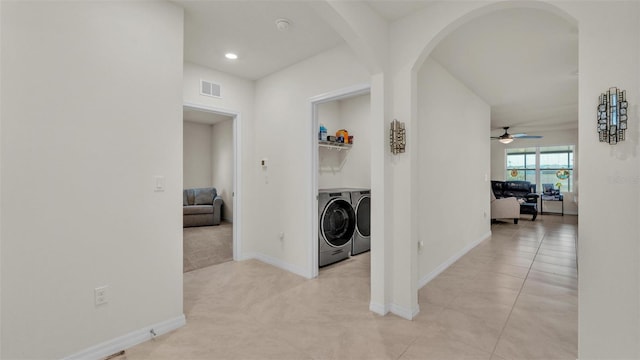hall featuring recessed lighting, independent washer and dryer, baseboards, arched walkways, and visible vents