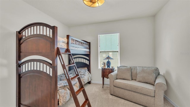 bedroom featuring baseboards and light colored carpet