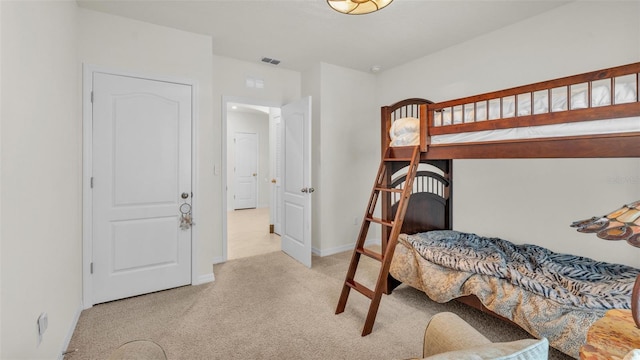 carpeted bedroom featuring baseboards and visible vents