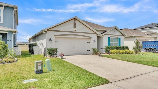 view of front of house featuring a front yard, driveway, stucco siding, and an attached garage