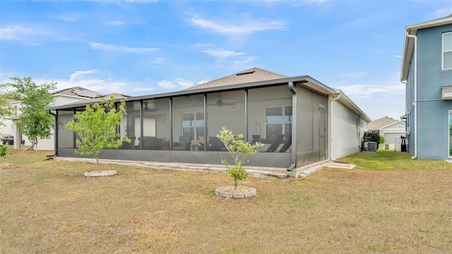 back of property with cooling unit, a sunroom, and a yard