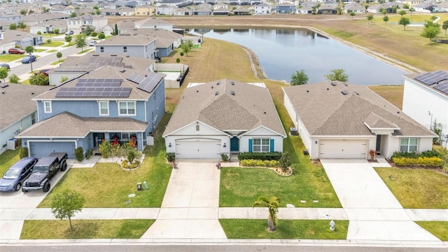 birds eye view of property with a residential view and a water view