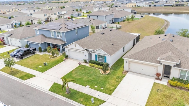 bird's eye view with a water view and a residential view