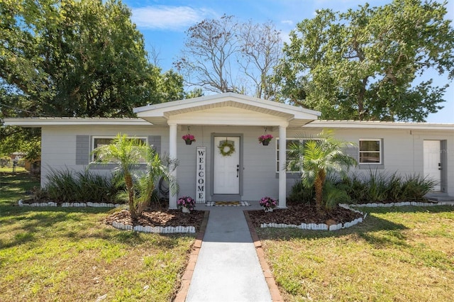 2410 NW Ave B, Winter Haven, FL 33880 - ranch-style home with a front lawn